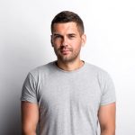 portrait-charming-young-man-standing-against-white-background