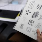 hand-holding-notebook-with-drew-brand-logo-creativ-PD54U75.jpg