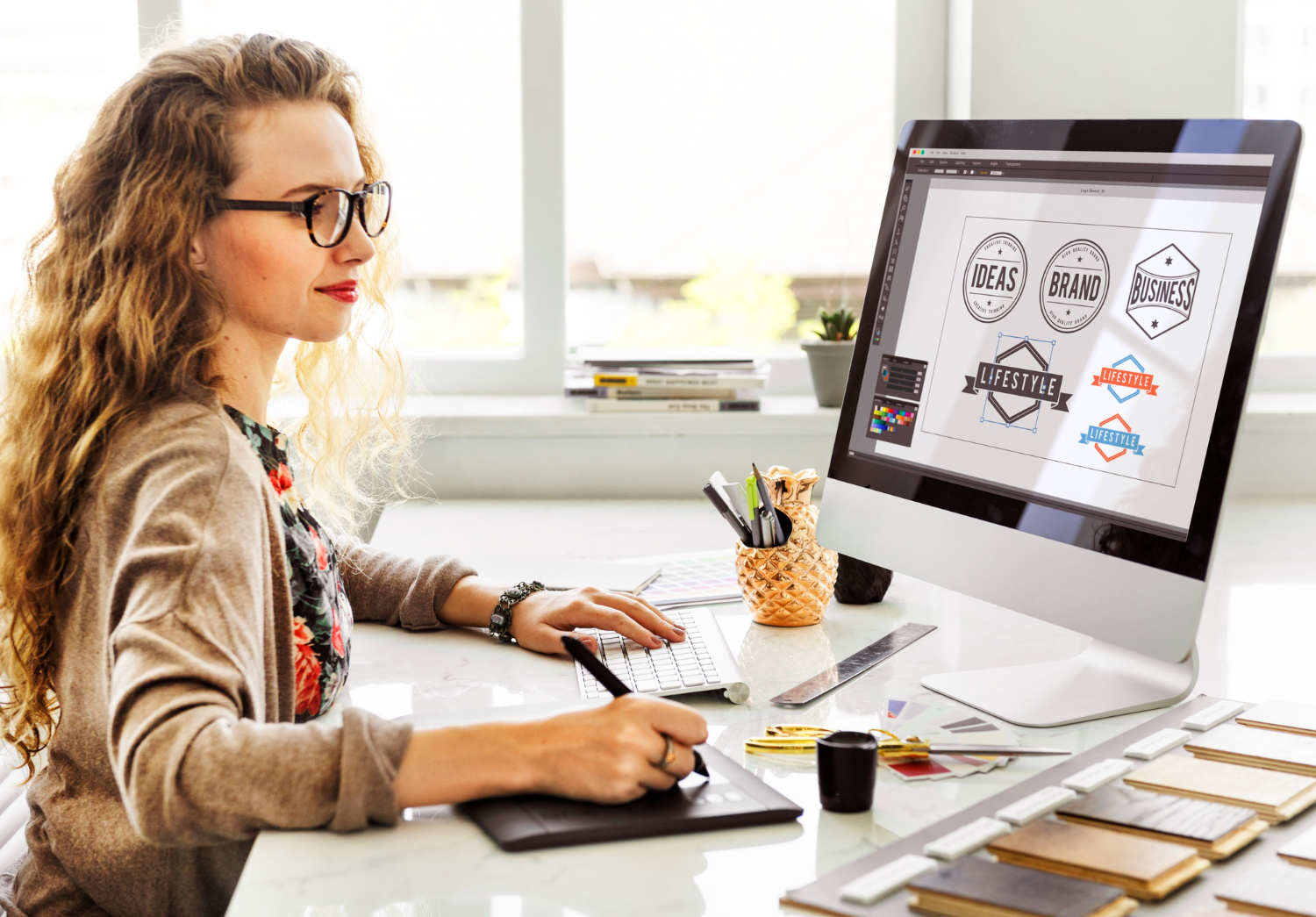woman designing logos on computer