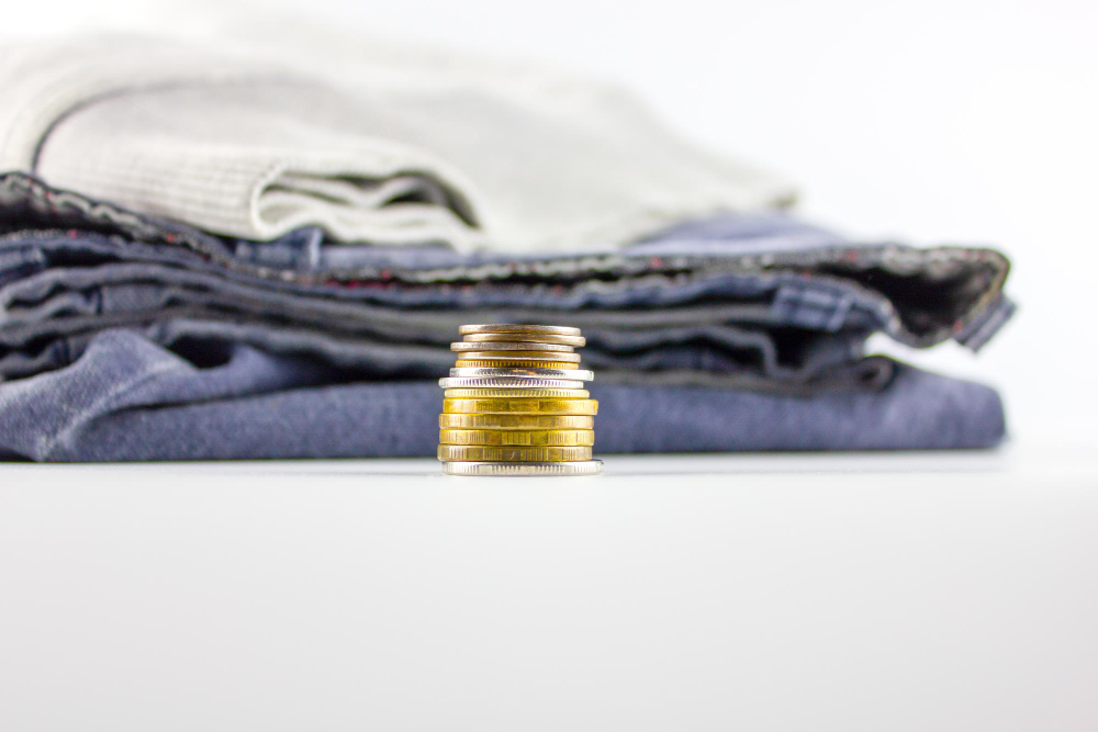 t-shirts sitting next to coins